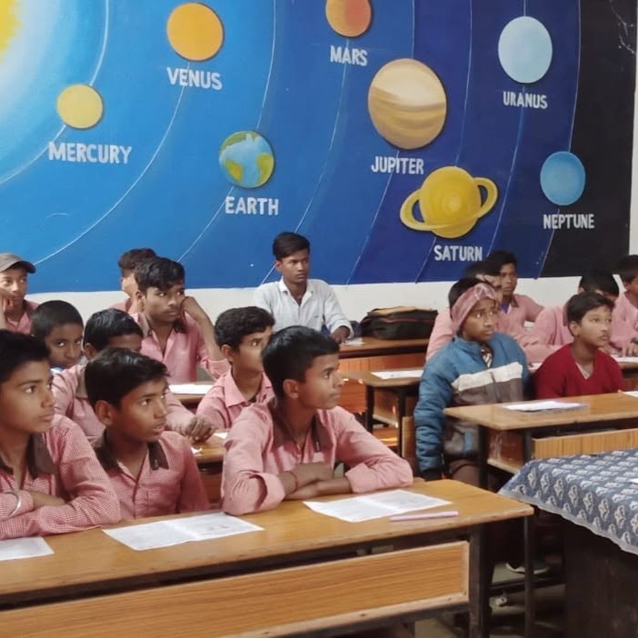 Children engaged in a Madhayam education or literacy activity